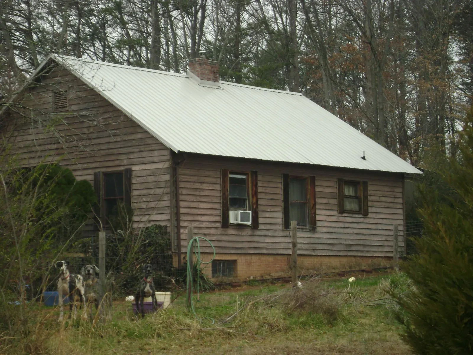 White metal roof on an old wood sided farmhouse, from a Metal Roof Installation job in Winneconne